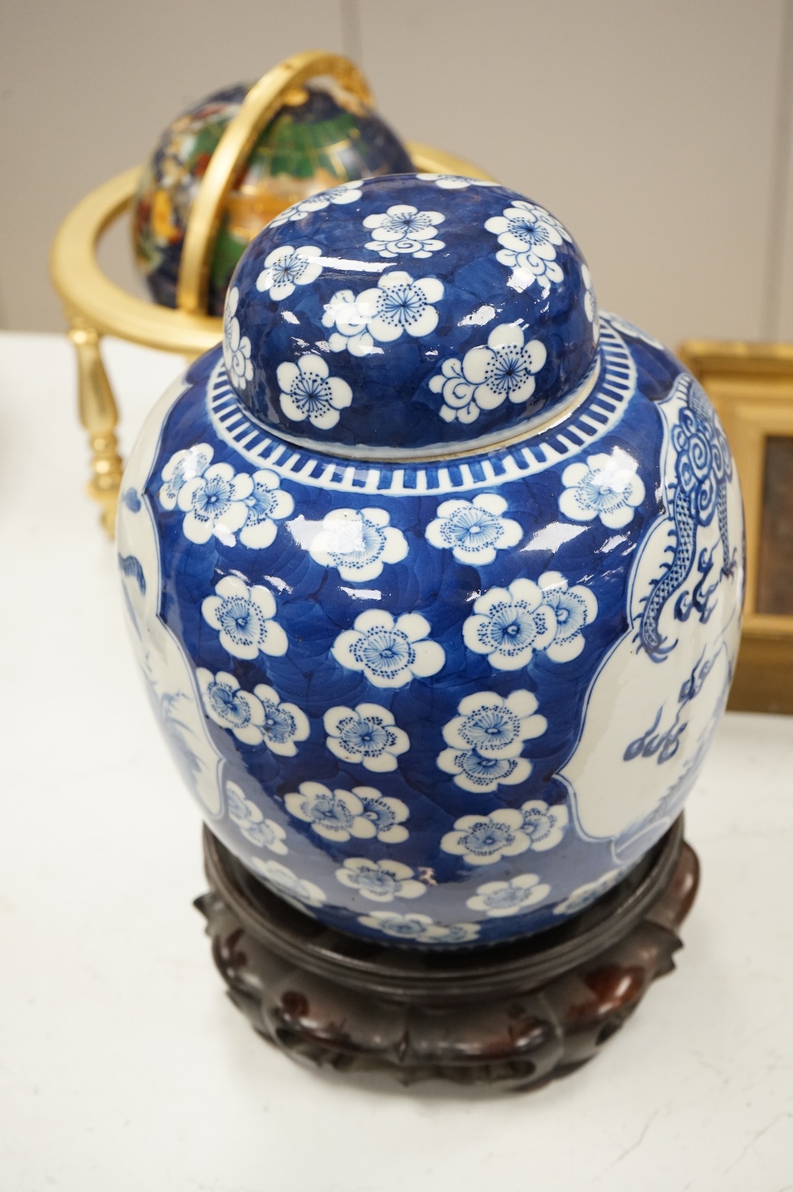 A 19th century Chinese blue and white jar and cover, on hardwood stand, 34cm high